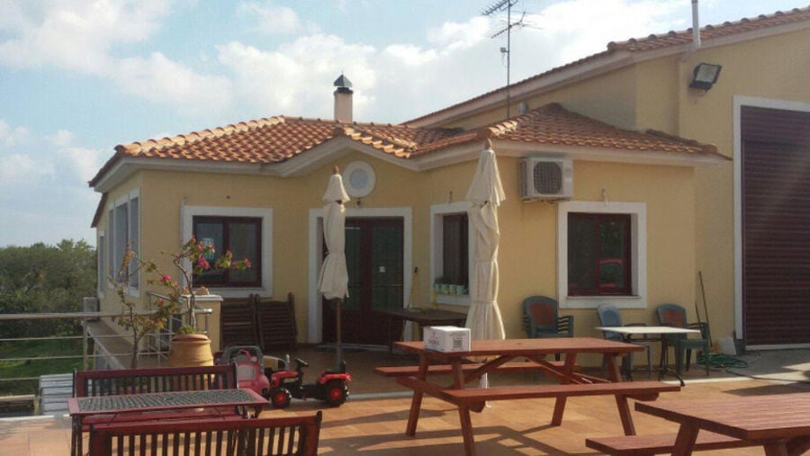 wood tables front the building of Vriniotis Winery